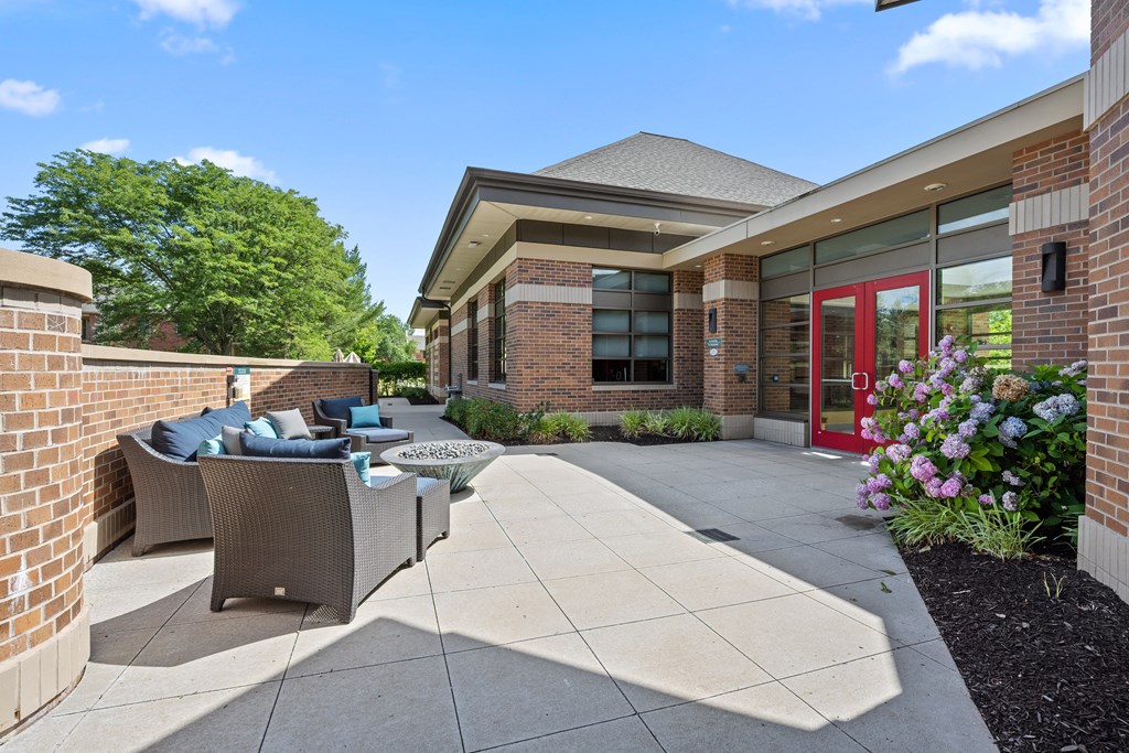 A building with a red door and a brick wall.