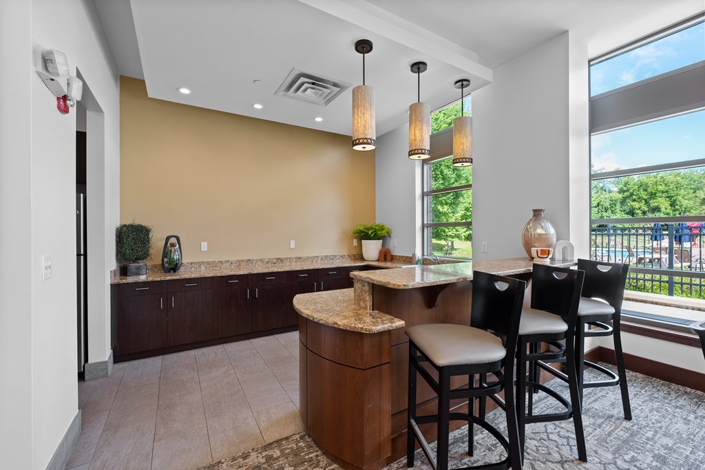 A kitchen with brown cabinets and a countertop with a marble top.