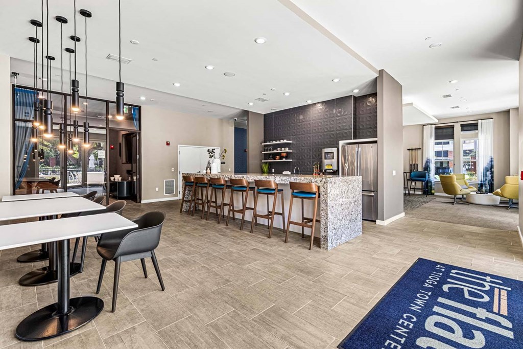 A modern dining area with a long table and chairs.