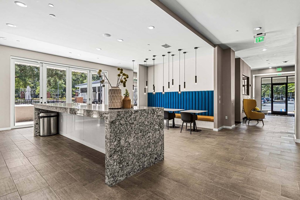 A reception area with a marble counter and a blue bench.
