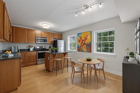 A kitchen with wooden cabinets and a black countertop.