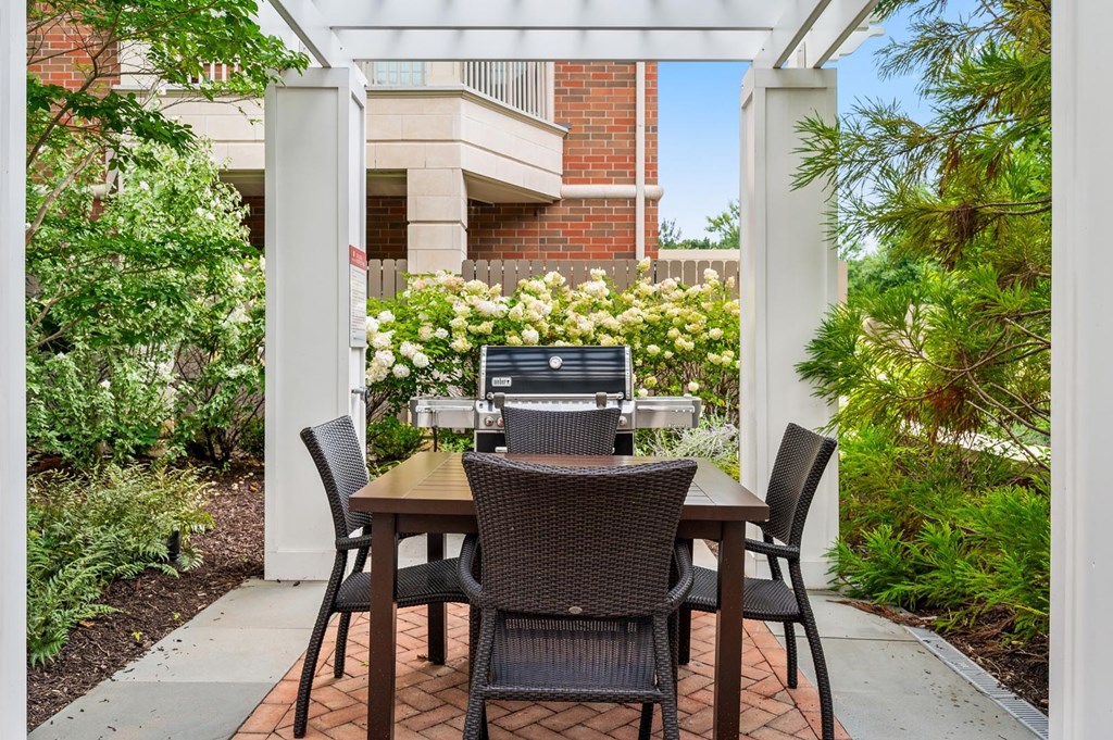 A patio with a table and chairs and a laptop on it.