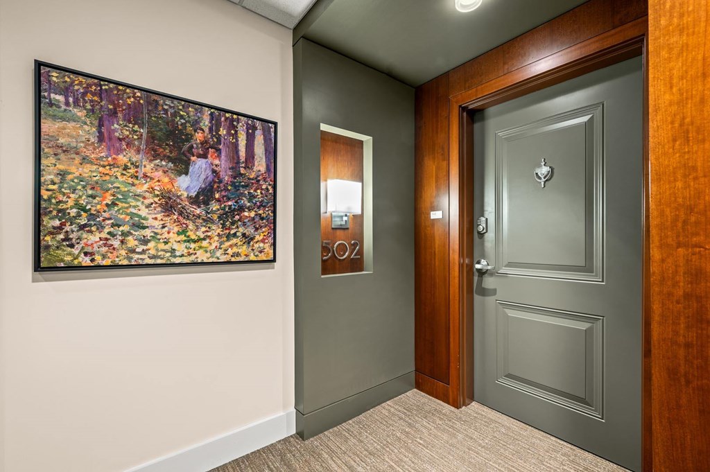 A painting of a woman in a forest is on the wall.