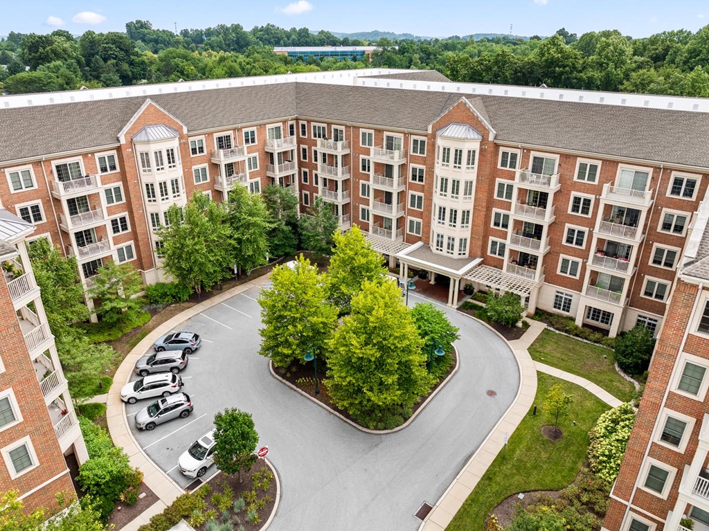 A large building with a parking lot in front of it.