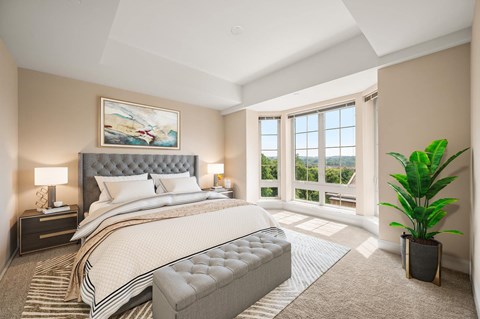 A bedroom with a large bed and a painting on the wall.