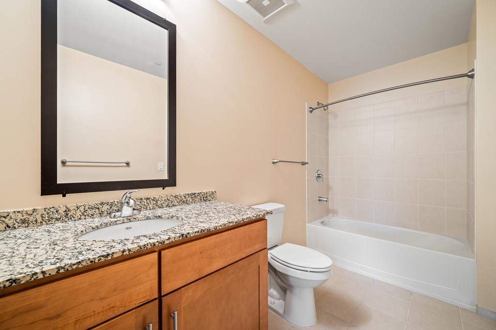A bathroom with a sink, toilet, and bathtub.