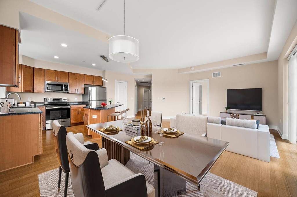 A modern kitchen with a dining table and chairs.