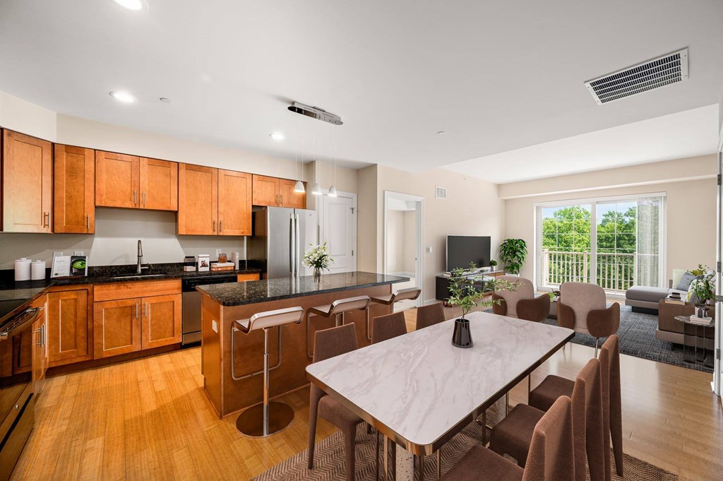 A modern kitchen with wooden cabinets and a dining table with chairs.