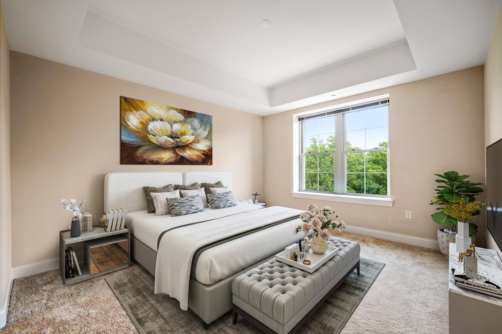 A bedroom with two beds and a painting on the wall.