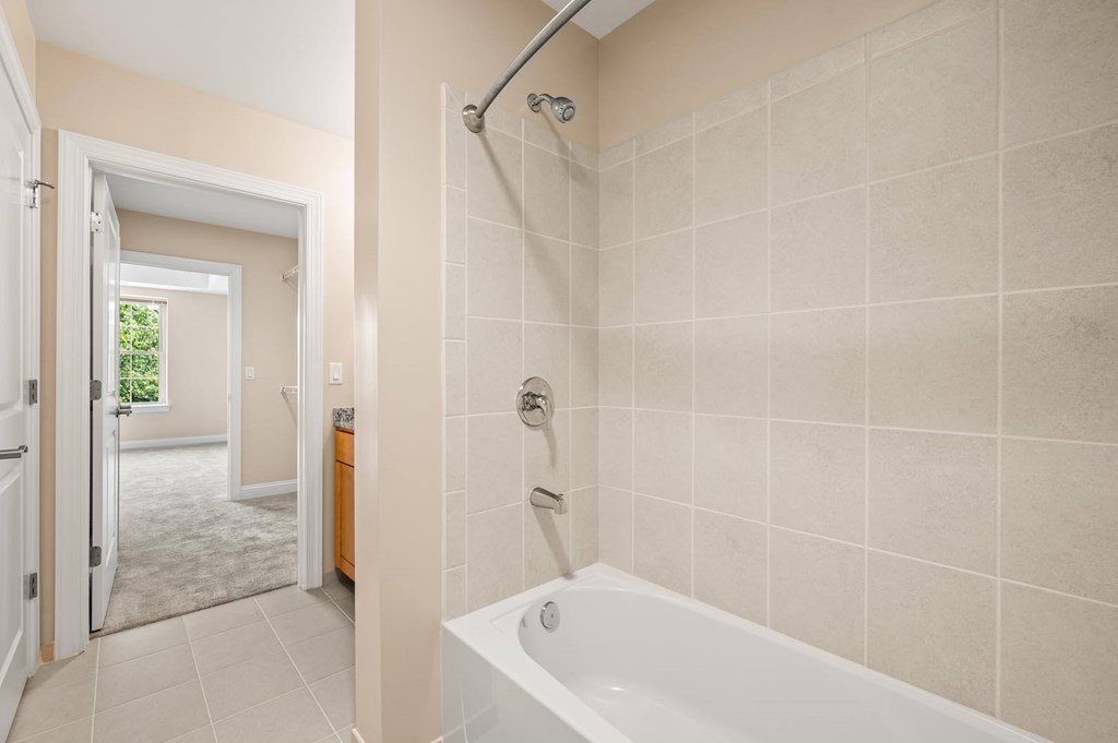 A bathroom with a white tub and a walk in shower.