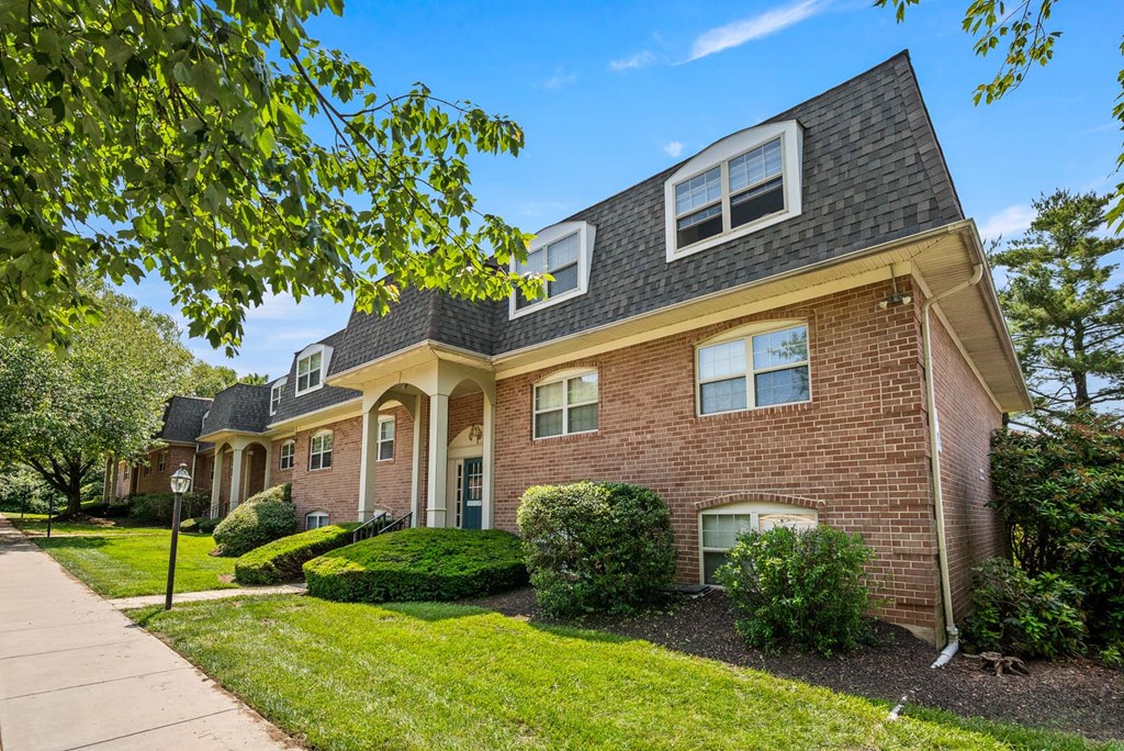 A house with a brick facade and a grey roof.