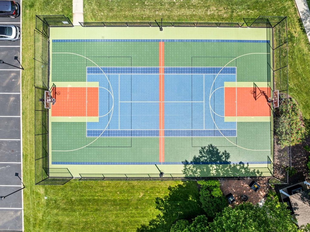 A basketball court with a blue and orange color scheme.