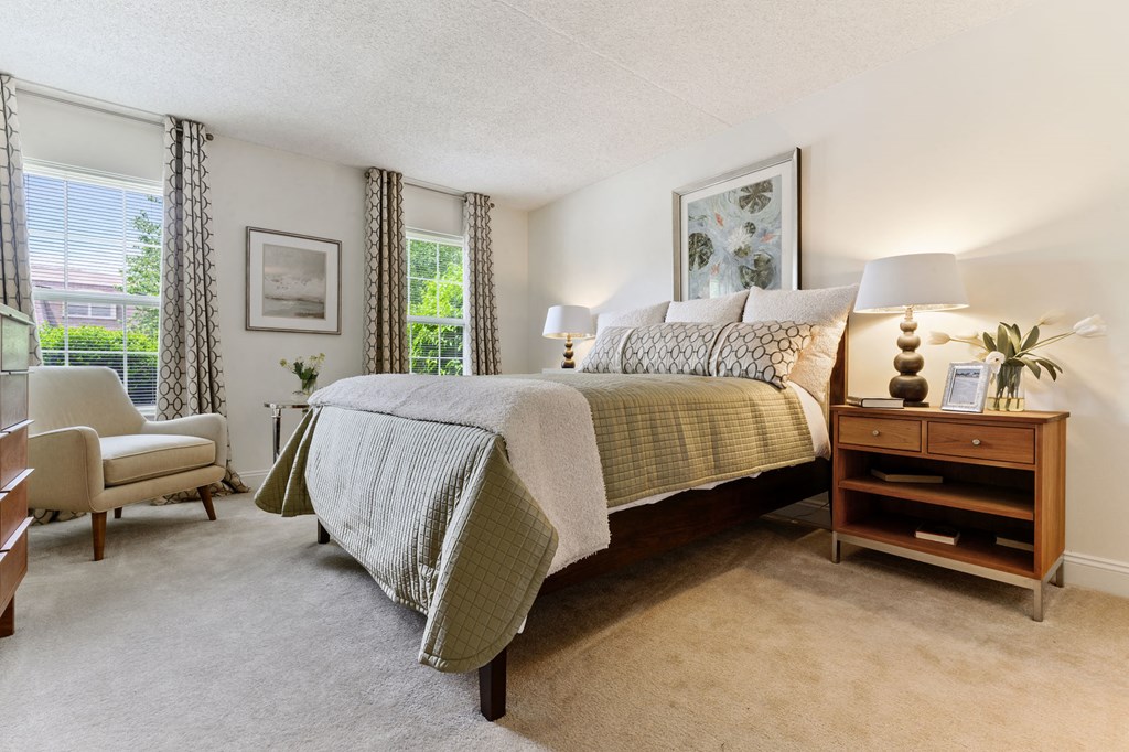 Bright and spacious bedroom with two windows, plush carpet flooring, and plenty of natural light in the Tahoe floor plan at New Kent Apartments, West Chester, PA