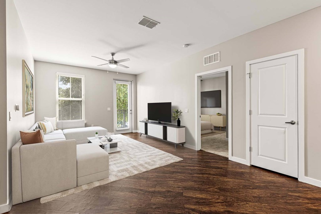 A living room with a white couch and a television.