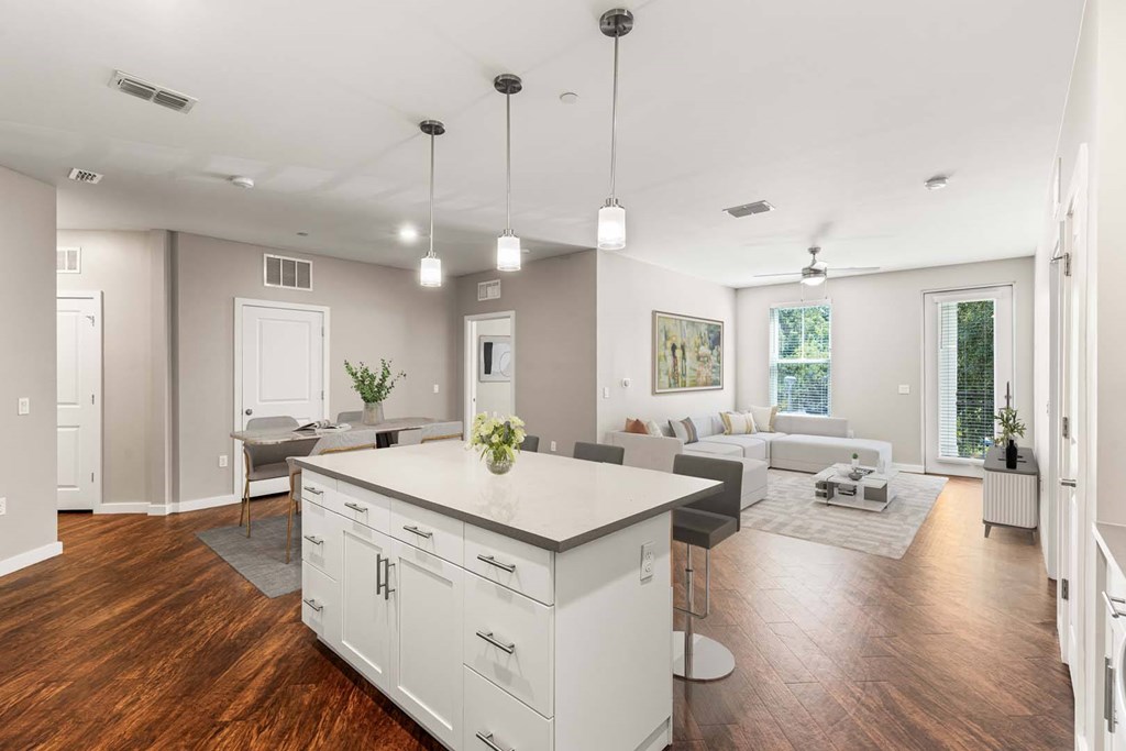 A modern kitchen with white cabinets and a large island.