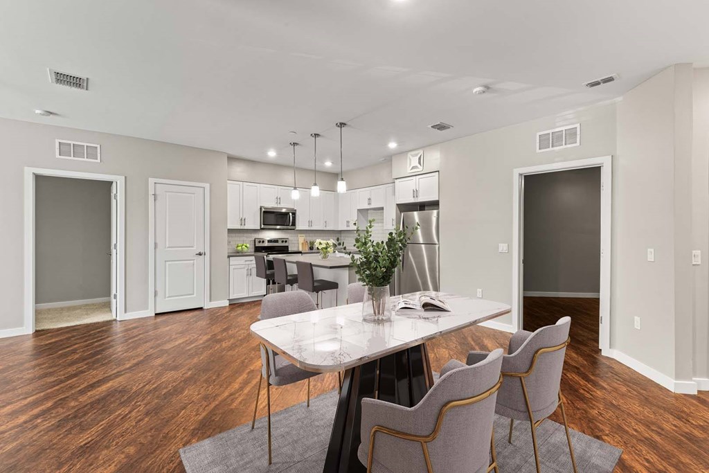 A dining room with a table and chairs.