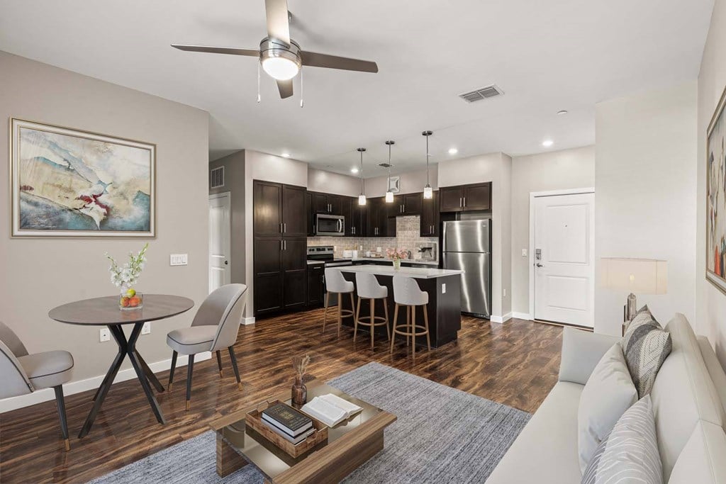 A modern kitchen with a dining table and chairs.