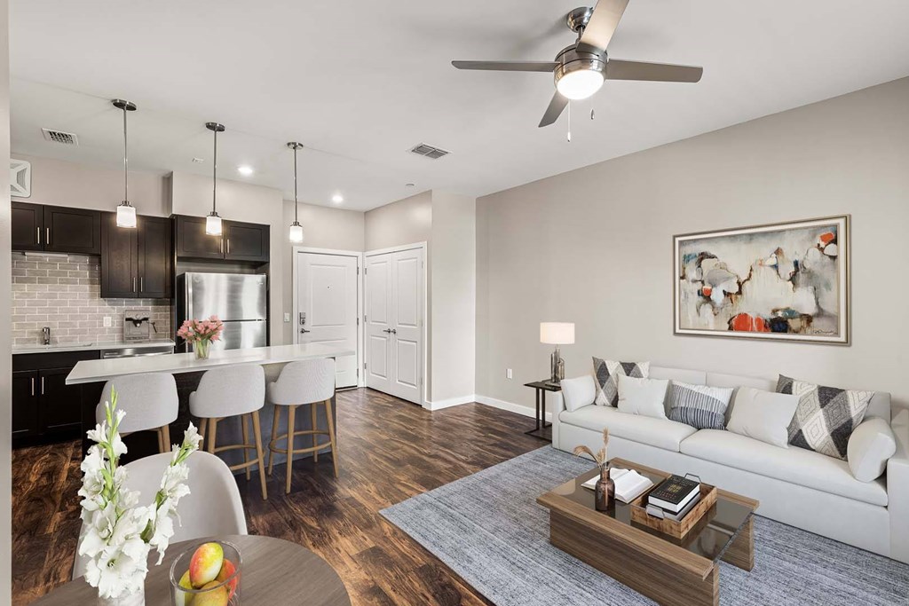 A modern kitchen with a dining area and a living room.