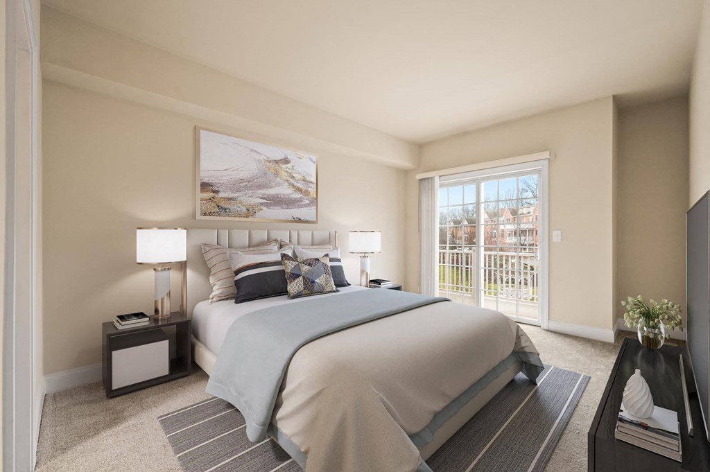 Cozy bedroom featuring a large bed and a framed painting on the wall at Claremont Apartments in Exton, PA