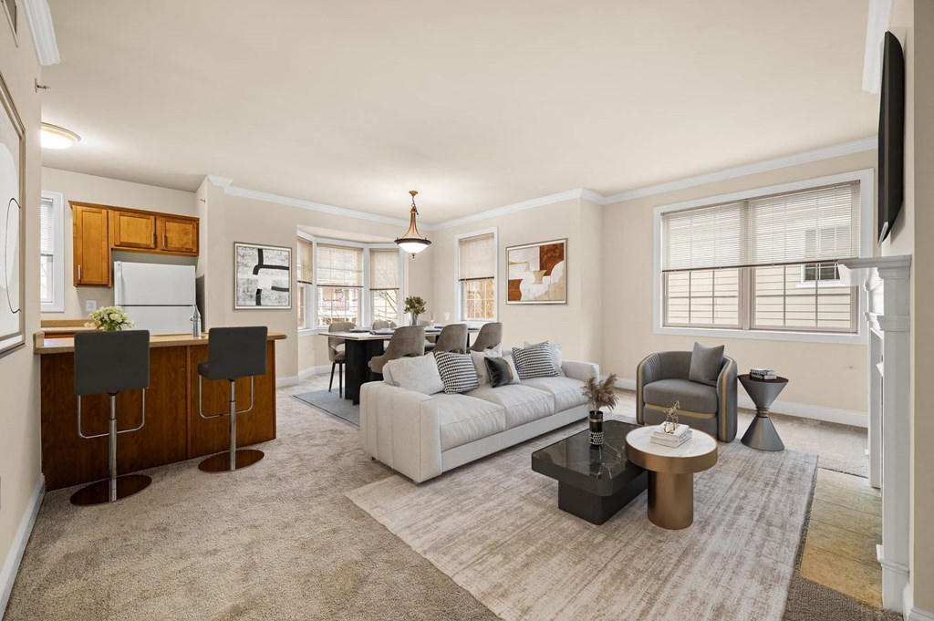 Modern living room with a white couch, coffee table, and flat-screen television at Claremont Apartments in Exton, PA
