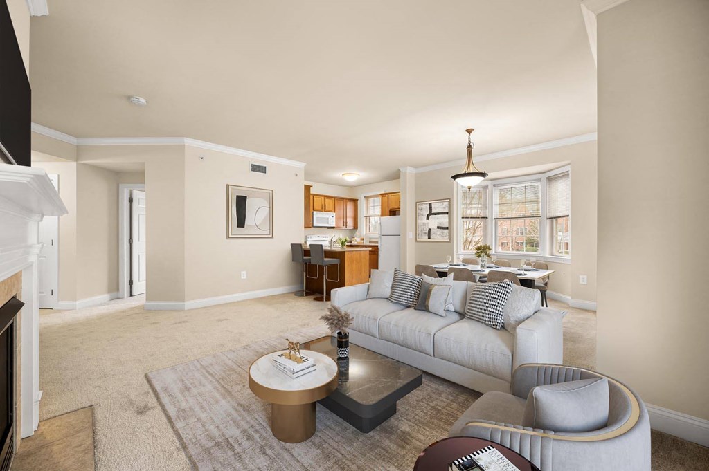 Spacious living room with a comfortable grey couch and a chic coffee table at Claremont Apartments in Exton, PA