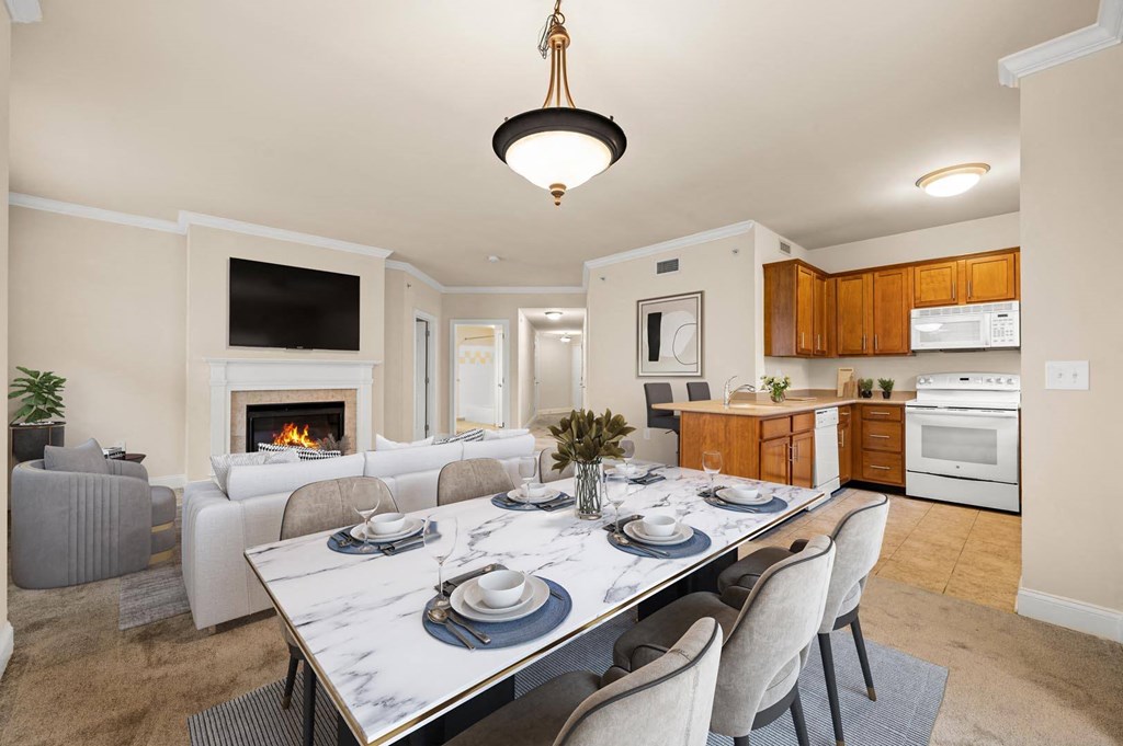 Modern dining room with a sleek marble table and stylish grey chairs at Claremont Apartments in Exton, PA