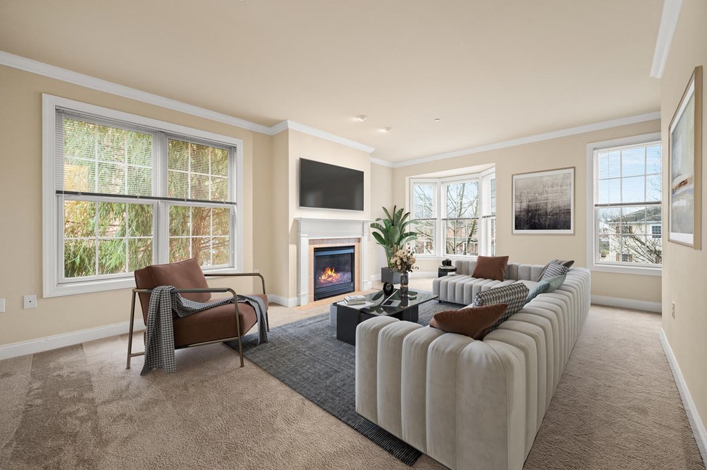 Cozy living room with a fireplace and a comfortable couch at Claremont Apartments in Exton, PA