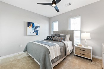 Apartment bedroom with grey walls and energy-efficient windows at Weatherstone Flats - Photo Gallery 6