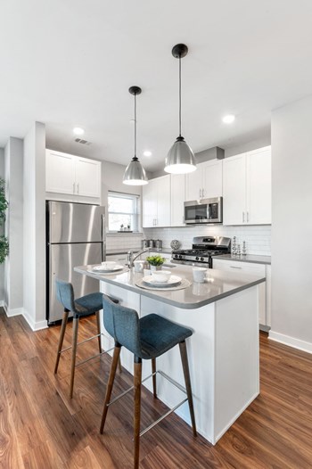 Designer apartment kitchen in Chester Springs, PA with large island and gray quartz counters - Photo Gallery 4