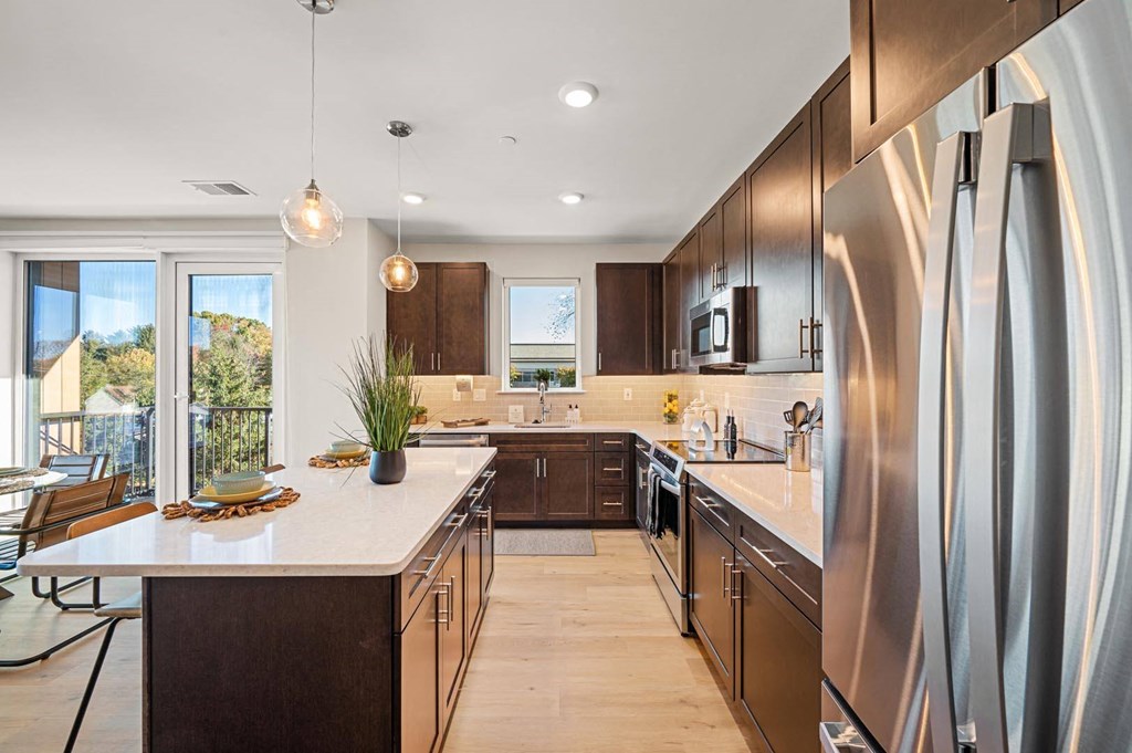 Spacious kitchen with sleek wooden cabinetry, stainless steel appliances, and granite countertops at Hamilton at Eagleview in Exton, PA