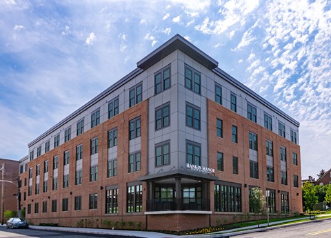 a large brick building with a street in front of it