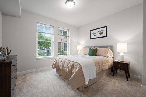 a bedroom with a bed and two windows