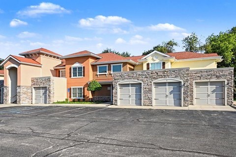 A row of houses with garages in front of them.