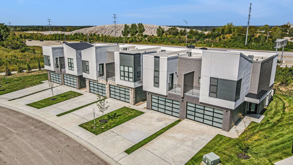 an aerial view of a building with green grass and trees