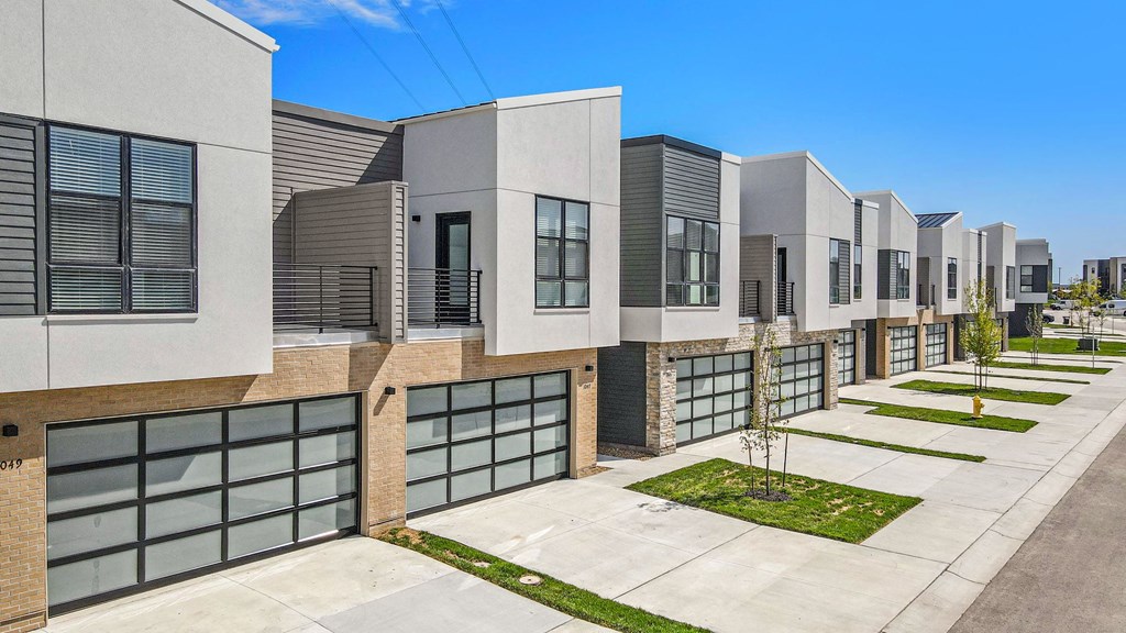 a row of modern buildings with glass doors and windows