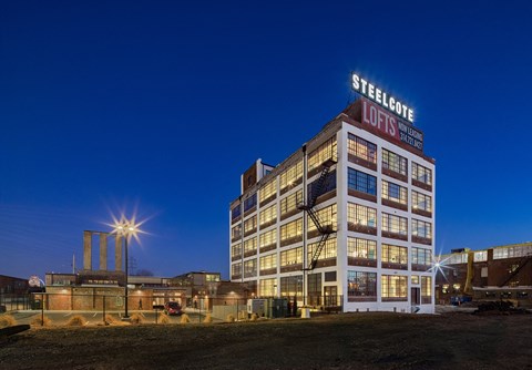 a large building with a sign on top of it at night