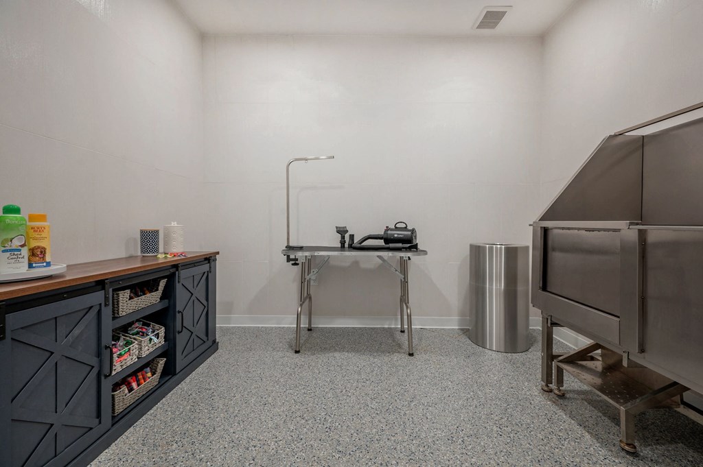 a kitchen with stainless steel appliances and a table  at Signature at West Pryor, Lee's Summit, MO