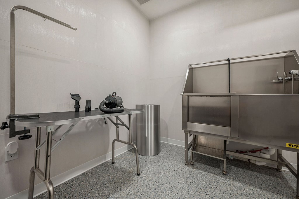 the kitchen has stainless steel appliances and a counter with a sink  at Signature at West Pryor, Missouri, 64081