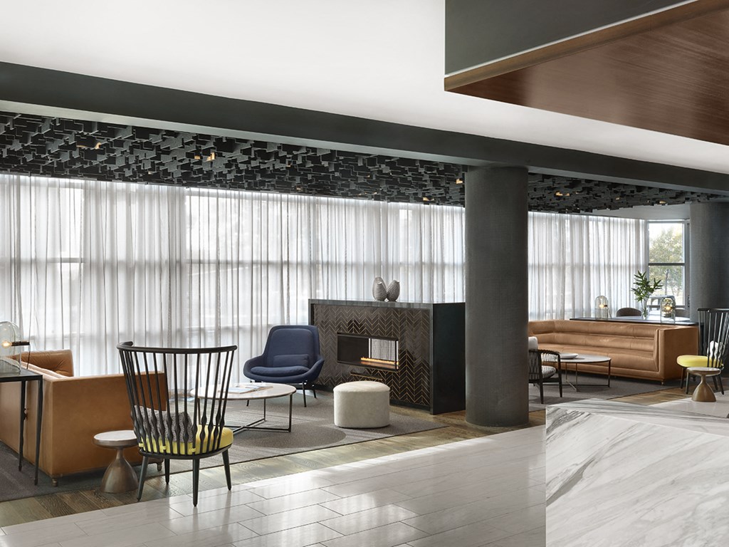 Lobby with marble flooring, conversational seating and full window wall  at Clayton On The Park, Clayton, Missouri