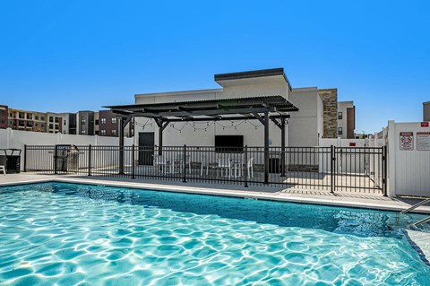 a swimming pool with a building in the background