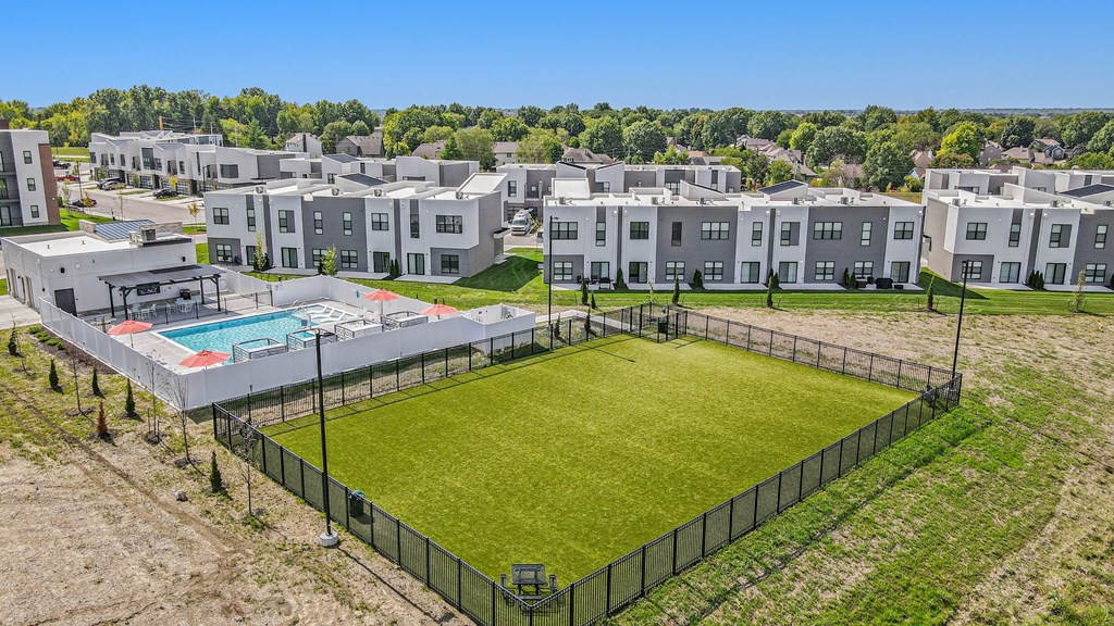 an aerial view of an apartment complex with a dog park and a pool  at Signature at West Pryor, Lee's Summit, MO