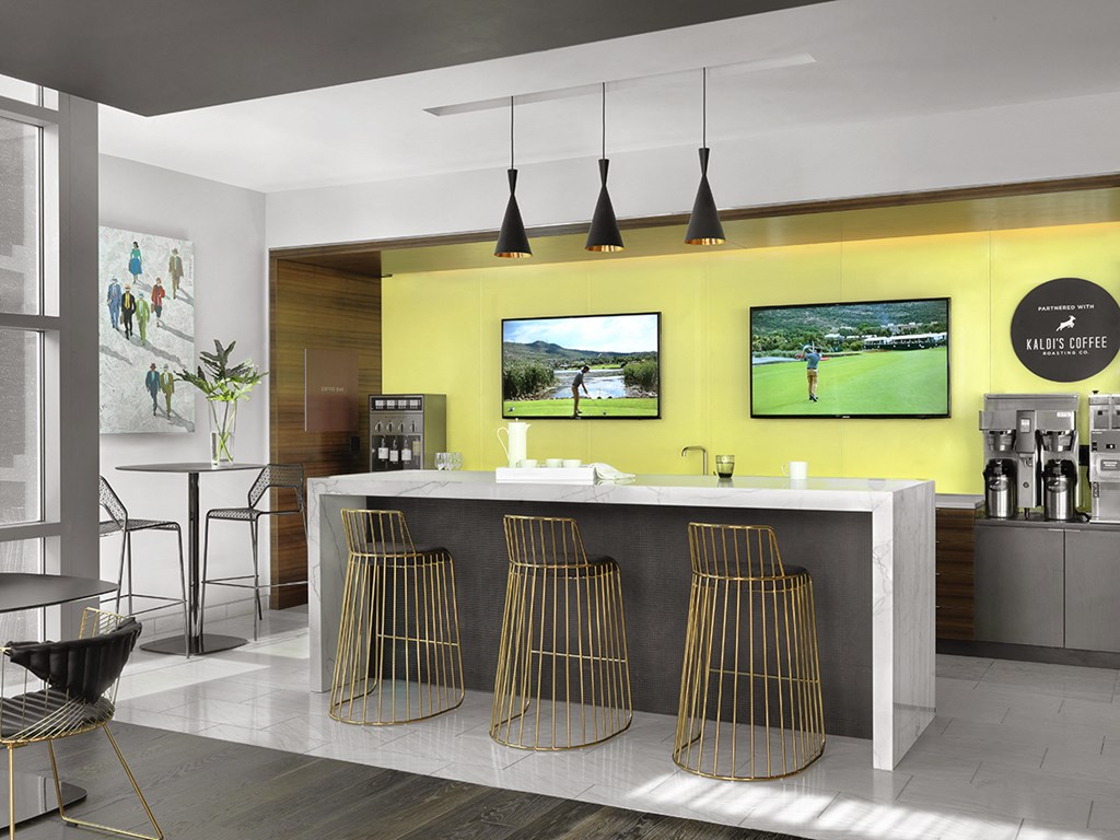 Lobby coffee bar with seating and two televisions  at Clayton On The Park, Clayton, 63105