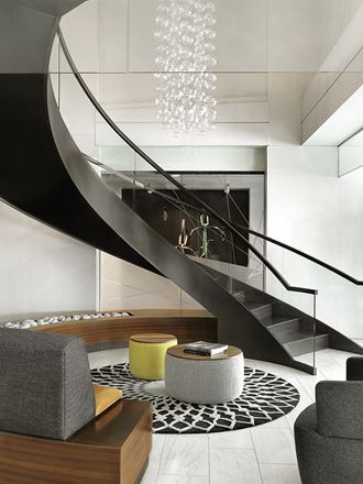 Lobby grand spiral staircase with curved sofa and round coffee table