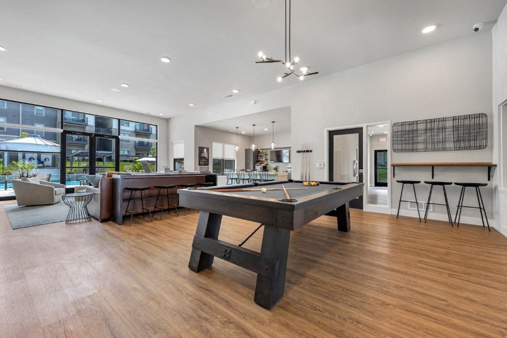 a game room with a pool table and a bar at The Prairie Luxury Apartments, Missouri
