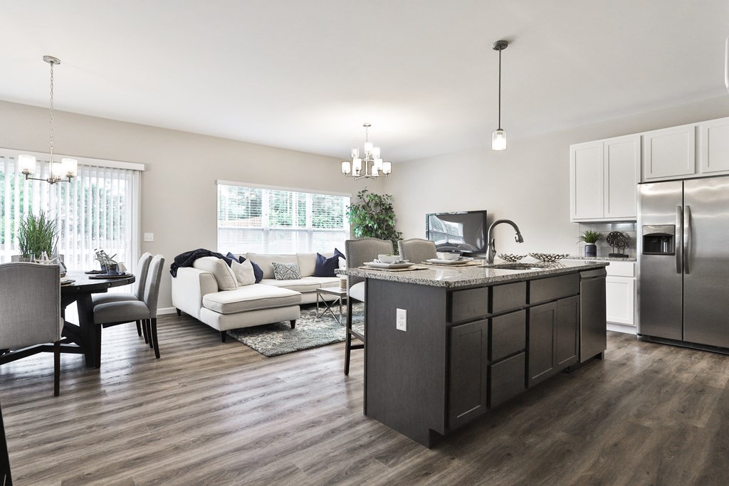a kitchen and living room with a refrigerator and a sink at The Willows, O'Fallon, MO