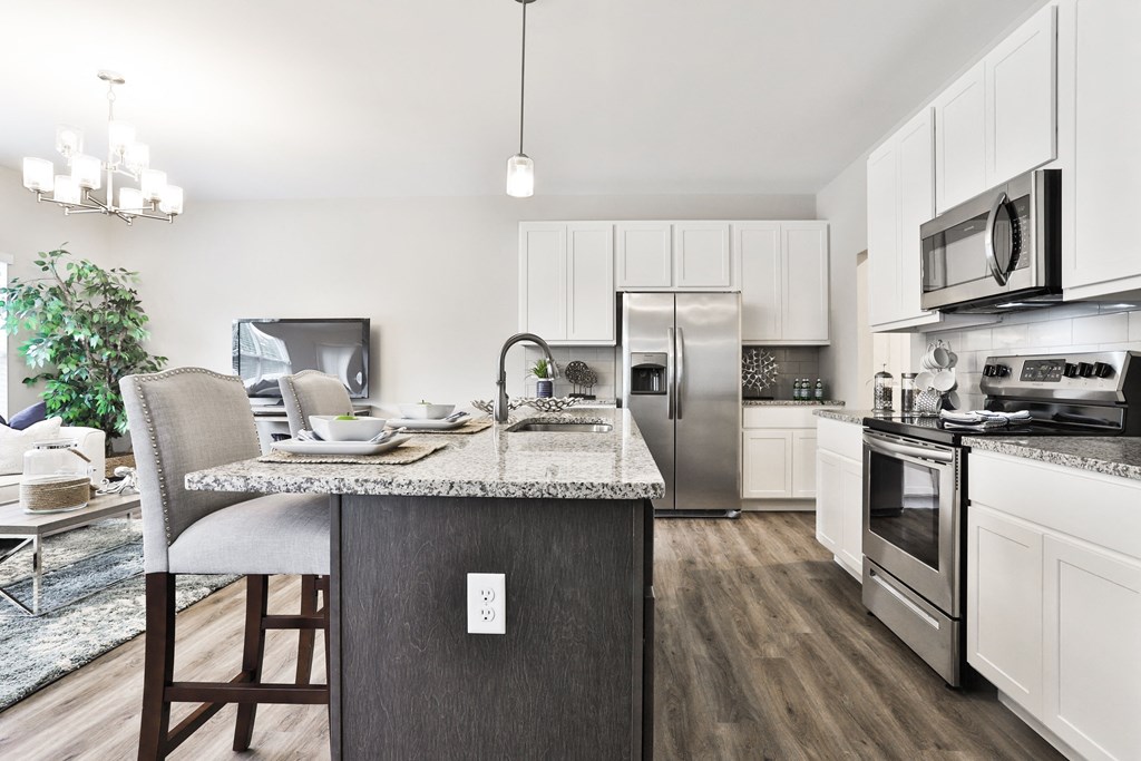 a kitchen with stainless steel appliances and a marble counter top