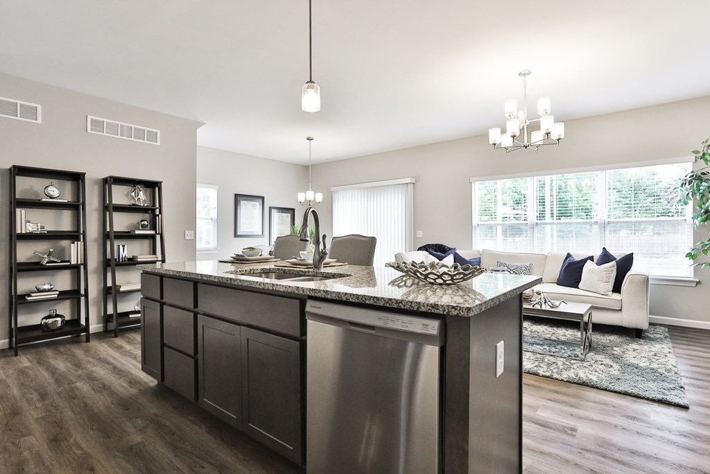 an open floor plan with a kitchen and living room at The Willows, O'Fallon Missouri