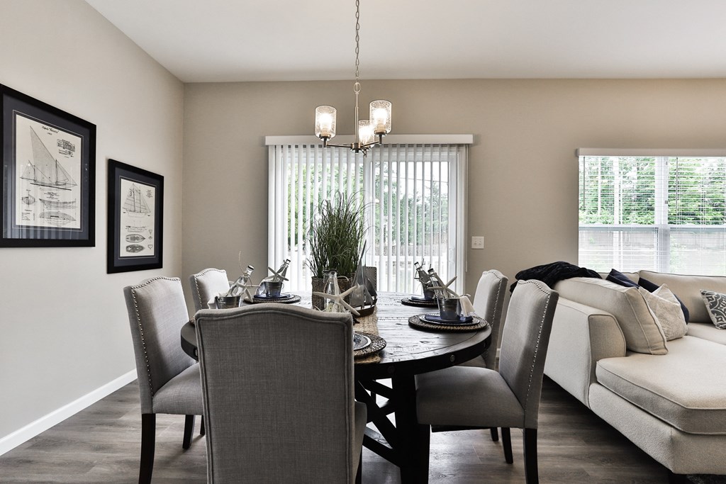 a dining room and living room with a table and chairs