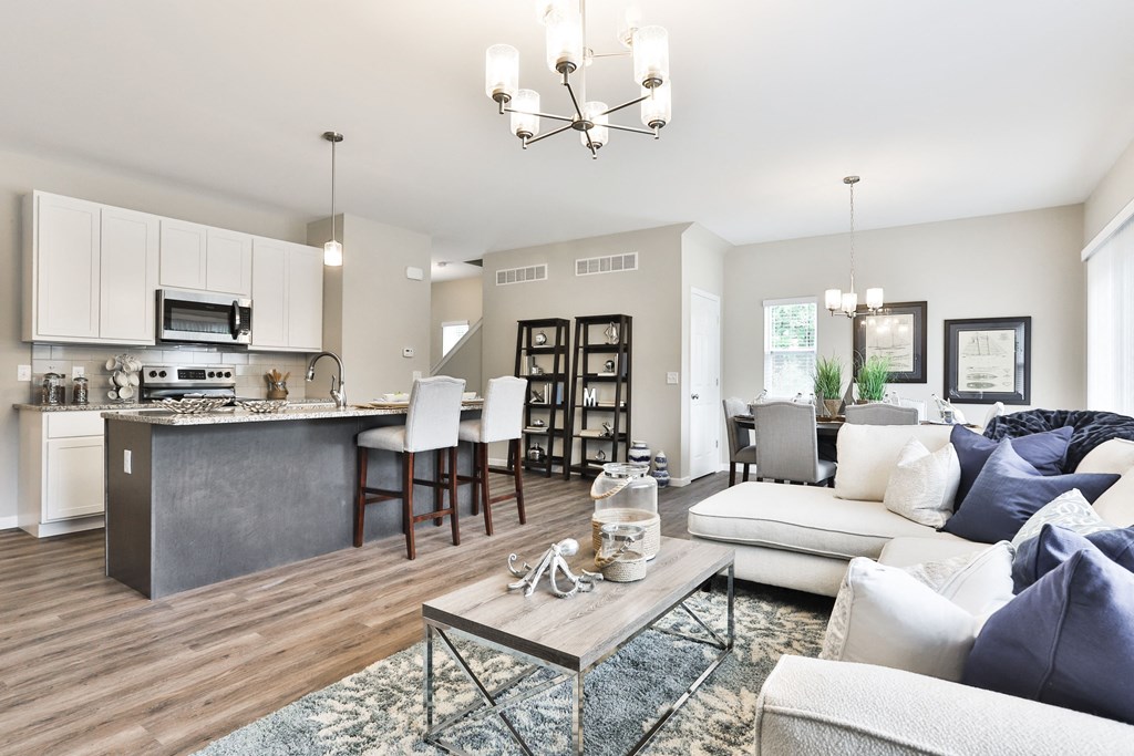 a living room and kitchen with a couch and a table at The Willows, O'Fallon, 63367