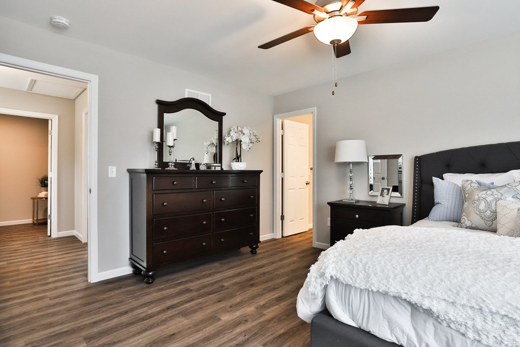 a bedroom with a bed and a dresser and a ceiling fan at The Willows, Missouri